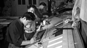 Japanese Americans working in the sign shop to earn money at Rohwer Camp